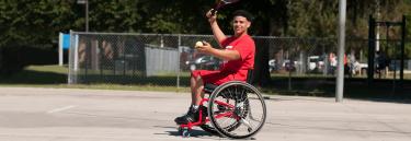 Sport wheelchair Top End Pro 2 red frame man playing tennis